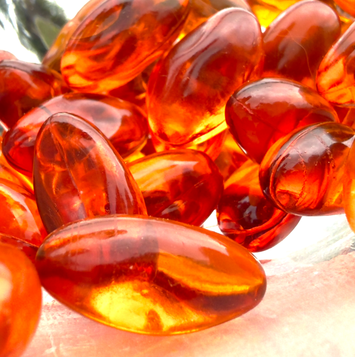 Close-up of clear orange Truemeric softgels